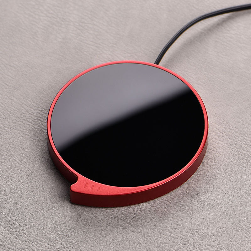 WarmSip smart coffee mug warmer pad on desk with hot beverage