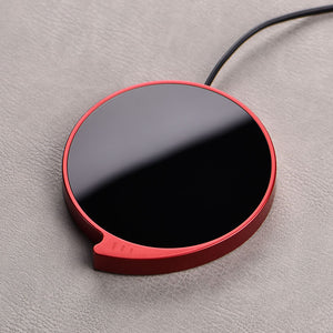 WarmSip smart coffee mug warmer pad on desk with hot beverage