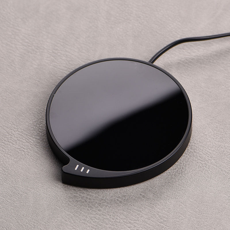 WarmSip smart coffee mug warmer pad on desk with hot beverage