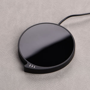 WarmSip smart coffee mug warmer pad on desk with hot beverage